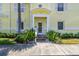 Charming yellow two-story home featuring a well-maintained front yard and a covered front entrance with white trim at 4984 Beach Se Dr # B, St Petersburg, FL 33705