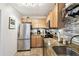Efficient kitchen features stainless steel appliances, granite countertops, and ample storage solutions for the home chef at 4984 Beach Se Dr # B, St Petersburg, FL 33705