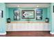 A decorative wall in the lounge area with a WYC flag, lighting and white cabinets at 4984 Beach Se Dr # B, St Petersburg, FL 33705