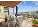 This covered brick patio features waterfront views, with seating for four, under blue umbrellas on a sunny day at 4984 Beach Se Dr # B, St Petersburg, FL 33705