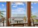 Relaxing balcony view of the ocean and pier with tables and chairs perfect for enjoying the scenery at 4984 Beach Se Dr # B, St Petersburg, FL 33705