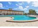 Large community pool with ample seating and beautiful architecture on a sunny day at 5200 Brittany S Dr # 1501, St Petersburg, FL 33715