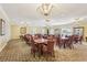 Community room with multiple tables and chairs, chandeliers, and large windows at 5200 Brittany S Dr # 1501, St Petersburg, FL 33715