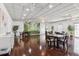 Open community room with hardwood floors, tables, chairs, and decorative plant mural at 5200 Brittany S Dr # 1501, St Petersburg, FL 33715