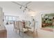 Formal dining room with a glass-top table and plush seating adjacent to a bright sitting area at 5200 Brittany S Dr # 1501, St Petersburg, FL 33715