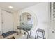 Foyer featuring round mirror, glass table, and neutral tones at 5200 Brittany S Dr # 1501, St Petersburg, FL 33715