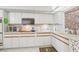 Bright kitchen features white cabinetry with modern appliances and ample counter space at 5200 Brittany S Dr # 1501, St Petersburg, FL 33715