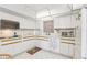 Bright kitchen featuring white cabinets, tile floors, and modern appliances with colorful accents at 5200 Brittany S Dr # 1501, St Petersburg, FL 33715