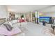 Expansive living room with a plush sofa, mirrored accents, and open access to the dining space at 5200 Brittany S Dr # 1501, St Petersburg, FL 33715