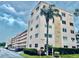 Multi-story condo complex with well-maintained landscaping and dedicated parking at 5623 80Th N St # 406, St Petersburg, FL 33709