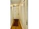 Hallway with wood-look flooring, showing an entry door and a closet for storage at 5623 80Th N St # 406, St Petersburg, FL 33709