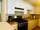 Functional kitchen with white cabinets, modern appliances, and a gas range at 5623 80Th N St # 406, St Petersburg, FL 33709