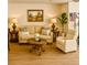 Comfortable living room featuring a couch, chair, tables, and decor at 5623 80Th N St # 406, St Petersburg, FL 33709