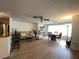 Open living space with a ceiling fan that connects to a dining area, showcasing natural light at 5623 80Th N St # 406, St Petersburg, FL 33709
