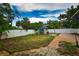 Private backyard with a lush lawn, featuring a storage shed and a secure fence at 5628 2Nd N Ave, St Petersburg, FL 33710