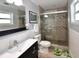 Bathroom featuring updated vanity, toilet, and shower with glass doors at 5628 2Nd N Ave, St Petersburg, FL 33710