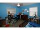 This is a baby's room with blue walls, light wood floors, and a ceiling fan at 5628 2Nd N Ave, St Petersburg, FL 33710