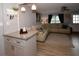 Bright living room seamlessly connected to a modern kitchen with white cabinets and granite countertops at 5628 2Nd N Ave, St Petersburg, FL 33710