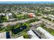 Overhead view of property with pond and water feature nestled amongst trees, near businesses, and featuring ample parking at 5695 40Th N Ave # 301, Kenneth City, FL 33709