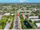 Bird's eye view of a property near businesses with nearby parking, landscaping, and lush mature trees at 5695 40Th N Ave # 301, Kenneth City, FL 33709