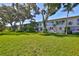 Exterior shot showcasing well-maintained lawn, mature trees and the building's facade at 5695 40Th N Ave # 301, Kenneth City, FL 33709