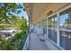 Relaxing tiled balcony features seating, lush plants, and serene neighborhood views at 5695 40Th N Ave # 301, Kenneth City, FL 33709