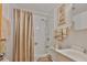 Bright bathroom features a shower with neutral-toned tile, coordinating accessories and a framed print at 5695 40Th N Ave # 301, Kenneth City, FL 33709