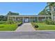 The exterior view shows the clubhouse with a brick facade, inviting entrance and manicured landscaping at 5695 40Th N Ave # 301, Kenneth City, FL 33709