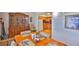 Dining room with wood table, china cabinet, wood floors and adjacent kitchen area at 5695 40Th N Ave # 301, Kenneth City, FL 33709
