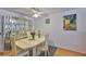 Dining area featuring a glass display cabinet, ceiling fan, and bright lighting at 5695 40Th N Ave # 301, Kenneth City, FL 33709