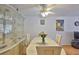 Dining area with glass display cabinet, ceiling fan, and view into living area at 5695 40Th N Ave # 301, Kenneth City, FL 33709