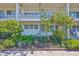 The exterior of the building shows balconies and lush landscaping at 5695 40Th N Ave # 301, Kenneth City, FL 33709