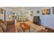 Spacious living area with a dining area, complemented by stylish decor and hardwood floors at 5695 40Th N Ave # 301, Kenneth City, FL 33709