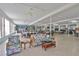 Large recreation room with sofas, tables, chairs and a ceiling fan at 5695 40Th N Ave # 301, Kenneth City, FL 33709
