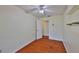 Bright bedroom with laminate flooring, ceiling fan, and an open shelf ready for your personal touches at 608 Fort Duquesna Dr, Sun City Center, FL 33573