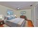 Comfortable bedroom with soft lighting, wood floors, and a neutral palette, promoting relaxation at 608 Fort Duquesna Dr, Sun City Center, FL 33573