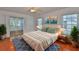 Inviting bedroom featuring a cozy bed, serene decor, and sliding glass doors leading to a sunroom at 608 Fort Duquesna Dr, Sun City Center, FL 33573