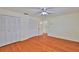 Bedroom featuring laminate flooring, a ceiling fan, a double door closet, and an open door to another room at 608 Fort Duquesna Dr, Sun City Center, FL 33573
