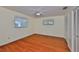 Spacious bedroom with laminate flooring, a ceiling fan, two windows, and a double door closet for ample storage at 608 Fort Duquesna Dr, Sun City Center, FL 33573
