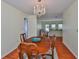Dining room with a chandelier and view into the living room at 608 Fort Duquesna Dr, Sun City Center, FL 33573