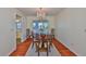 Formal dining room with hardwood floors and a decorative chandelier at 608 Fort Duquesna Dr, Sun City Center, FL 33573