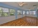 Spacious Florida room featuring multiple windows and wood floors at 608 Fort Duquesna Dr, Sun City Center, FL 33573