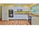 Updated kitchen featuring white cabinets, modern appliances, and stylish flooring at 608 Fort Duquesna Dr, Sun City Center, FL 33573