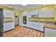 Spacious kitchen with white cabinets, modern appliances, and wood-look flooring at 608 Fort Duquesna Dr, Sun City Center, FL 33573