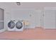 Spacious laundry room equipped with washer, dryer, utility sink, and storage cabinets at 608 Fort Duquesna Dr, Sun City Center, FL 33573