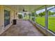 Enclosed patio area with tiled floors and a view of the well-maintained yard perfect for relaxation and entertainment at 608 Fort Duquesna Dr, Sun City Center, FL 33573