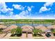 Aerial view of villas surrounding a scenic lake with lush landscaping at 6327 Positano Ct, Sarasota, FL 34243
