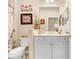 Cozy bathroom featuring a white vanity, decorative art, and a shower/tub combo at 6327 Positano Ct, Sarasota, FL 34243