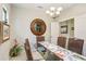 Elegant dining room featuring a glass table, wicker chairs, and a decorative chandelier at 6327 Positano Ct, Sarasota, FL 34243