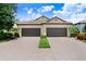 Charming villa with a tile roof, brick driveway and manicured landscaping at 6327 Positano Ct, Sarasota, FL 34243
